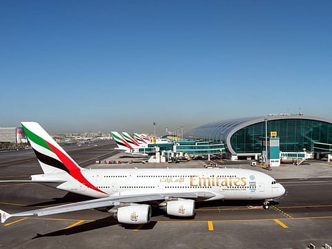 Emirates airline aircraft at the parking bay of concourse three at Dubai International Airport.