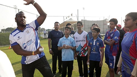 West Indies allrounder Andre Russell gives tips to youngsters during the Zurich Cricket Sixes tournament at the Sevens Stadium on Friday.