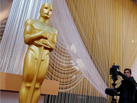 A camera crew runs through a shot movement around an Oscar statue in preparation for the 92nd Academy Awards in Los Angeles