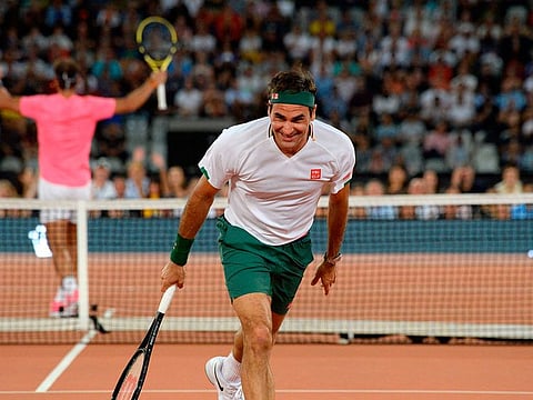 Roger Federer has a laugh during the game with Rafael Nadal