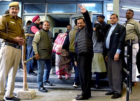 Delhi Chief Minister Arvind Kejriwal arrives with his family members to cast his vote during the Delhi Assembly elections, at Civil Lines in New Delhi on Saturday.