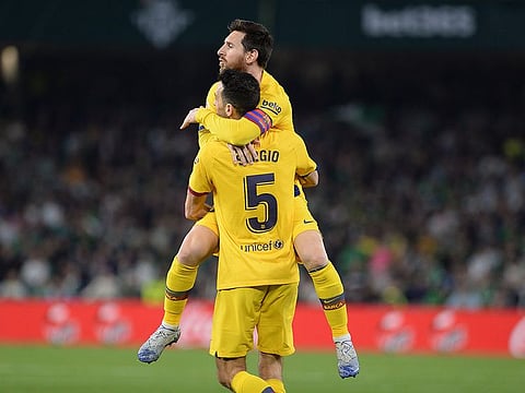 Sergio Busquets celebrates his goal with Lionel Messi.