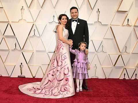 Syrian filmmaker Waad Al-Kateab (L), Hamza Al-Kateab (C) and Sama Al-Kateab, of "Sama" arrive for the 92nd Oscars at the Dolby Theatre in Hollywood
