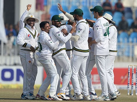 Pakistan team members celebrate after the dismissal of a Bangladesh batsman during their Test match in Rawalpindi.