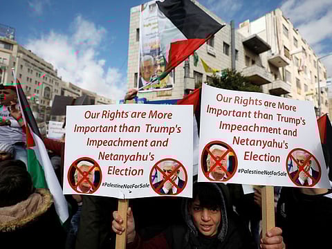 Palestinian demonstrators take part in a rally in support of President Mahmoud Abbas and against the US President Donald Trump's Middle East peace plan, in Ramallah in the Israeli-occupied West Bank on Tuesday.