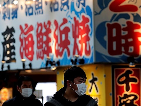 Pedestrians wearing surgical masks near Tokyo