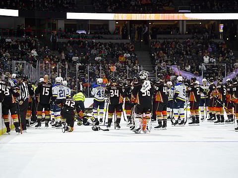 Members of the St. Louis Blues and Anaheim Ducks gather on the ice as Blues defenseman Jay Bouwmeester, who suffered a medical emergency, is worked on by medical personnel during the first period of an NHL hockey game Tuesday, Feb. 11, 2020, in Anaheim
