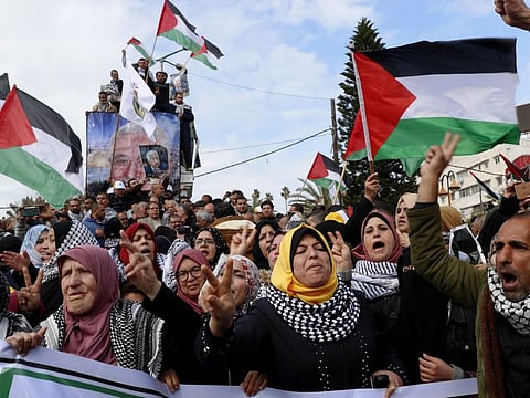 Protesters wave Palestinian flags as they chant slogans during a rally supporting Palestinian President Mahmoud Abbas and against the Middle East peace plan announced by US President Donald Trump, at the Unknown Soldier Square in Gaza City on February 11, 2020.