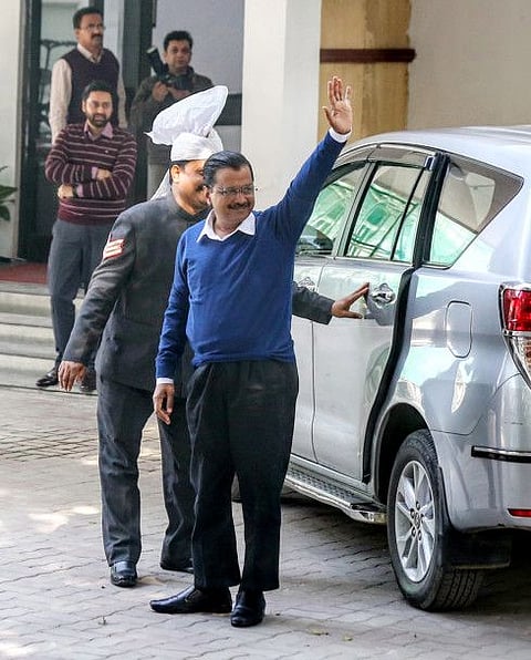 Delhi Chief Minister Arvind Kejriwal greets the crowd as he arrives to meet Delhi Lieutenant Governor Anil Baijal, in New Delhi yesterday.