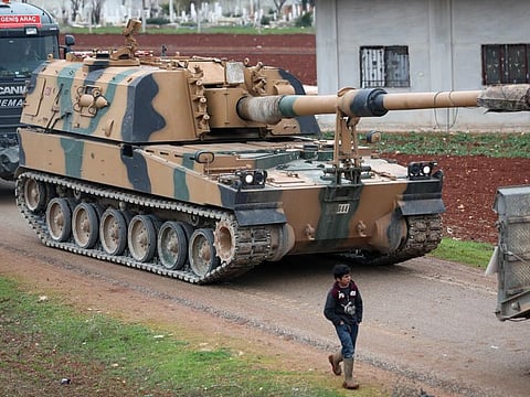 A child walkes past a Turkish 155mm self-propelled artillery gun in the town of Binnish in Syrias northwestern province of Idlib, near the Syria-Turkey border on February 12.