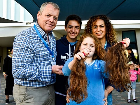 Kimia Mackay, seen her with her parents, suffers from Angelman Syndrome. On February 13, she donated her hair to prepare wigs for cancer patients