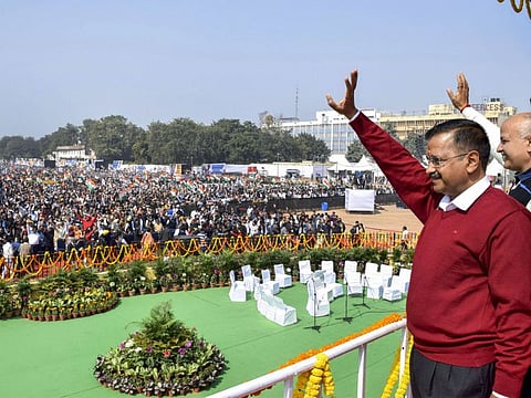 Delhi Chief Minister Arvind Kejriwal and newly sworn-in minister Manish Sisodia wave at the crowd after their oath ceremony at Ramlila Maidan in New Delhi on February 16, 2020.