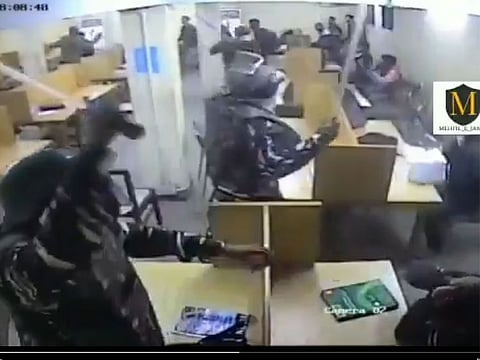A screen-grab from the video shows police assaulting students seated inside the library.