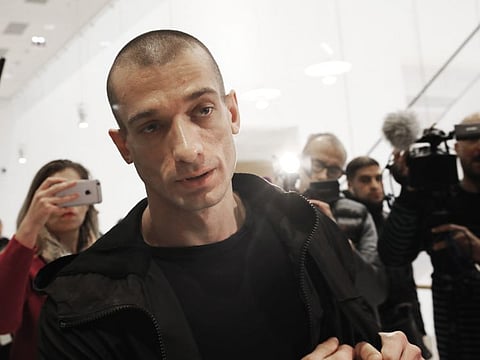 In this Janurary 10, 2019 file photo, Russian performance artist Pyotr Pavlensky arrives at the Paris courthouse, as he goes on trial after he set fire to the facade of France's central bank in Paris. Pyotr Pavlensky, noted for macabre, politically charged actions reportedly claimed responsibility for the online video posts that apparently prompted Benjamin Griveaux's resignation.