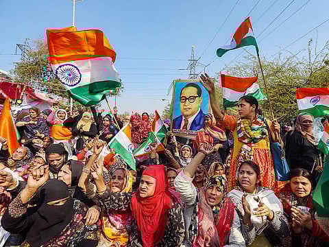 Women wave the tricolour during their protest against the Citizenship Amendment Act at Shaheen Bagh in New Delhi in February, 2020.