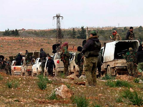 In this photo released Sunday, Feb. 16, 2020 by the Syrian official news agency SANA, Syrian government forces patrol the village of Tallet Shweihna, in Aleppo province, Syria.