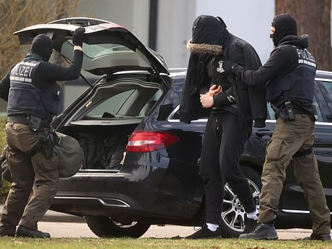 One of twelve men suspected of involvement in a far-right group is escorted by police as he arrives for his hearing at Germany's general prosecutor in Karlsruhe , Germany, February 15, 2020. REUTERS/Kai Pfaffenbach