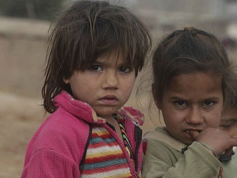 Afghan refugee children who fled their country, walk in the Kabobayan refugee camp in Peshawar, Pakistan on February 13. After 40 years, more than 1. 5 million Afghans still live as refugees in Pakistan.