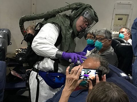 Temperature check aboard one of the charter flights carrying Americans who were evacuated from the Diamond Princess cruise ship in Japan back to the US