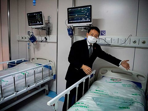 Lu Hongzhou, co-director of the Shanghai Public Health Clinical Center, gestures as he shows the quarantine room for COVID-19 coronavirus patients at the hospital building A2, in Shanghai