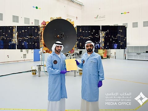 File photo of Sheikh Mohammed bin Rashid Al Maktoum (R) and Sheikh Hamdan bin Mohammed bin Rashid Al Maktoum (L) witnessing installation of the last metal piece of Hope Probe