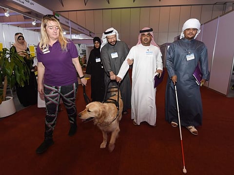 Visually impaired people trialing guide dog training during the Sight ME Exhibition organised by Emirates Association at Expo Centre Sharjah on February 11