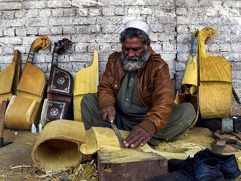 In this picture taken on December 10, 2019, a worker makes a traditional rabab musical instrument in a workplace on the outskirts of Peshawar. For years the distinctive twang of Pashtun music was drowned out by rattling gunfire and deafening explosions as musicians in Pakistan's northwest were targeted by militants. But, as security improves, a centuries-old tribal tradition is staging a comeback. - TO GO WITH Pakistan-Taliban-militancy-music-culture,FOCUS by David STOUT and Sajjad TARAKZAI
/ AFP / Abdul MAJEED / TO GO WITH Pakistan-Taliban-militancy-music-culture,FOCUS by David STOUT and Sajjad TARAKZAI