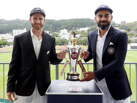 Virat Kohli (right) and Kane Williamson pose with the winner's trophy at stake with the scenic Basin Reserve at the backdrop.
