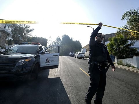 A police officer guards outside a Hollywood Hills home where a fatal shooting occurred on Wednesday, Feb. 19, 2020, in Los Angeles. (AP Photo/Ringo H.W. Chiu)