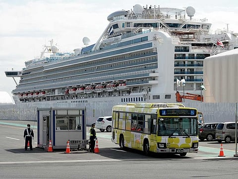 A bus carrying the passengers from the quarantined Diamond Princess cruise ship leaves a port in Yokohama, near Tokyo.