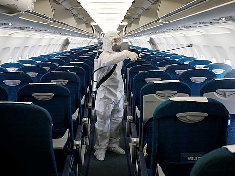 A health worker sprays disinfectant inside an airplane to protect from the coronavirus outbreak