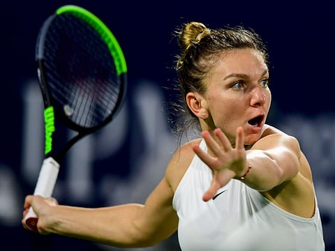 Romania's Simona Halep returns the ball to US' Jennifer Brady during their Dubai Tennis Championships semi-final match in the Gulf emirate on February 21, 2020.