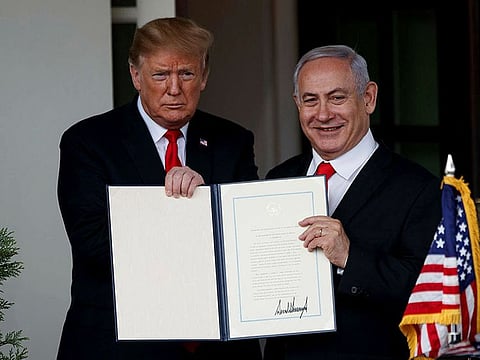 Israeli Prime Minister Benjamin Netanyahu holds up a signed proclamation with US President Donald Trump.