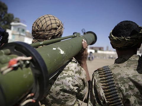 A Houthi rebel fighter holds his weapon during a gathering.