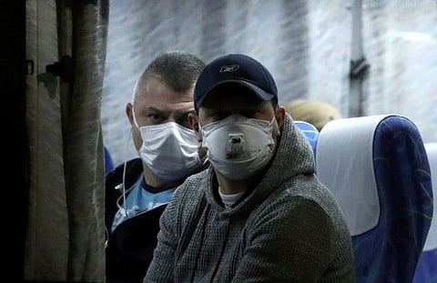 Passengers look on from a bus as they leave the coronavirus-hit cruise ship Diamond Princess at Daikoku Pier Cruise Terminal in Yokohama, south of Tokyo, Japan February 21, 2020.