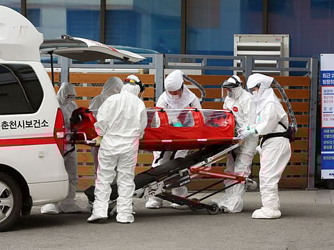 Medical workers wearing protective gear carry a patient infected with the COVID-19 coronavirus at a hospital in Chuncheon on February 22, 2020. South Korea reported 142 more coronavirus cases on February 22, the sharpest spike in infections yet, with more than half of the new cases linked to a hospital in a southern city. The national toll of 346 is now the second-highest outside of China. - - South Korea OUT / REPUBLIC OF KOREA OUT NO ARCHIVES RESTRICTED TO SUBSCRIPTION USE
/ AFP / YONHAP / - / REPUBLIC OF KOREA OUT NO ARCHIVES RESTRICTED TO SUBSCRIPTION USE