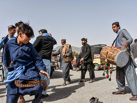Men and youth dance as they celebrate the first day of 'reduction in violence' agreed between the Taliban, US and Afghan forces in Kandahar province on February 22, 2020.