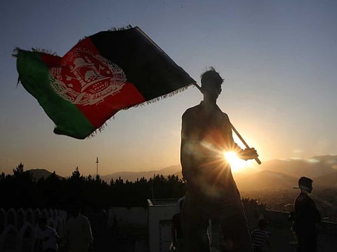 A man waves an Afghan flag during Independence Day celebrations in Kabul, Afghanistan, on August 19, 2019.