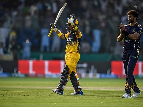 Peshawar Zalmi's Kamran Akmal celebrates his century during the Pakistan Super League (PSL) match against Quetta Gladiators