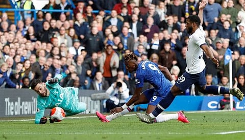 Tottenham Hotspur goalkeeper Hugo Lloris (green) scrambles to make a save from Chelsea's Tammy Abraham during their Premiership game on Saturday.