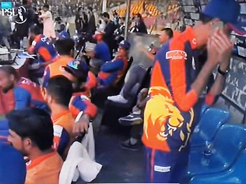 The Karachi Kings official on the mobile phone