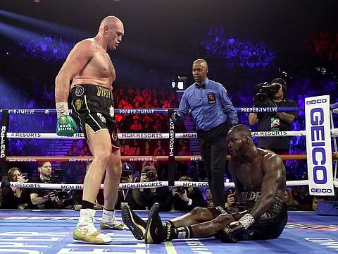 Tyson Fury knocks down Deontay Wilder in the fifth during their Heavyweight bout for Wilder's WBC and Fury's lineal heavyweight title.