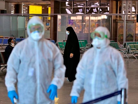 Medical staff prepare to check passengers arriving from Iran in the airport in Najaf