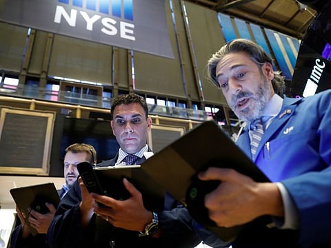Traders work on the floor of the New York Stock Exchange (NYSE) in New York. Global markets are seen pressured this week amid growing concerns on the deadly virus’ spread outside China.