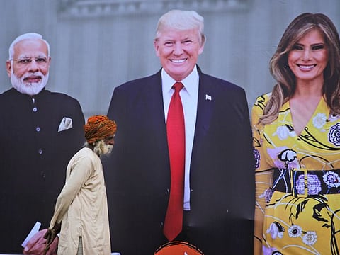 An elderly man walks past a giant hoarding welcoming U.S. President Donald Trump in Agra, India, Sunday, Feb. 23, 2020. Trump and the First Lady Melania Trump will be visiting Taj Mahal during their visit two-day trip to India. (AP Photo/Rajesh Kumar Singh)