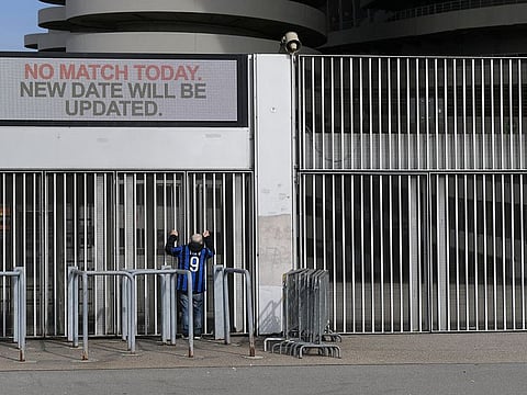 A man stands outside the San Siro stadium after the Inter Milan v Sampdoria Serie A match was cancelled due to an outbreak of the coronavirus in Lombardy and Veneto, in Milan, Italy, February 23, 2020.