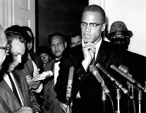 In this May 16, 1963, file photo, civil rights leader Malcolm X speaks to reporters in Washington, D.C.