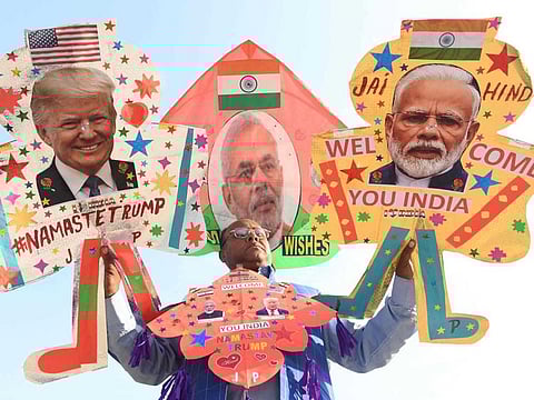 A kitemaker poses with kites decorated with the pictures of US President Donald Trump and India's Prime Minister Narendra Modi, in Amritsar on February 23, 2020, ahead of Trump's visit to India.