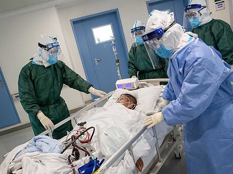 Medical staff transferring a patient infected by the COVID-19 coronavirus at a hospital in Wuhan in China's central Hubei province.