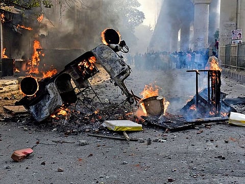 Vehicles set ablaze during clashes between anti-CAA protestors and Supporters group of the Citizenship act, at Jafrabad in North-East Delhi on Monday.